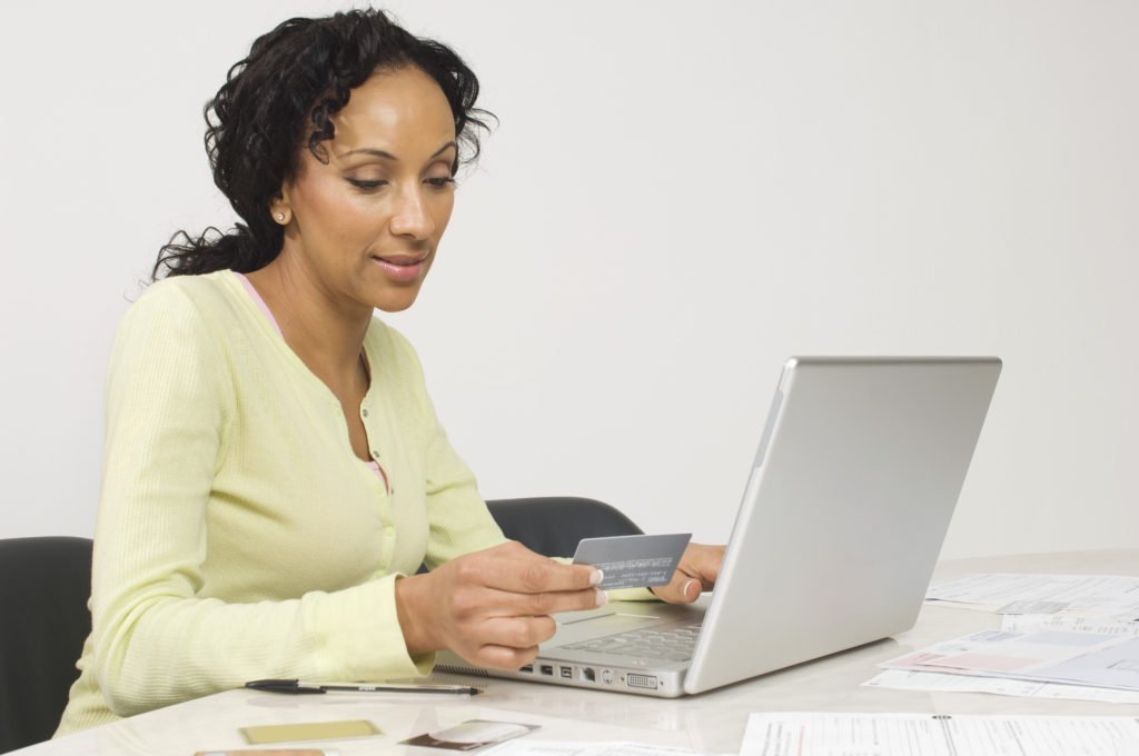 woman paying her credit card on time, save interest by paying credit card on time